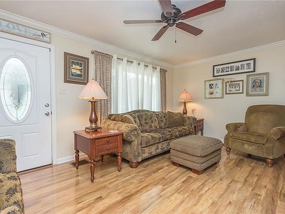 Spacious living room with gleaming wood floors.