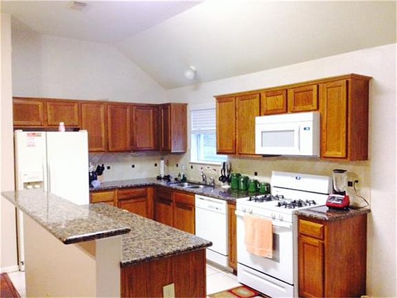 Great kitchen with bar that over looks living room.