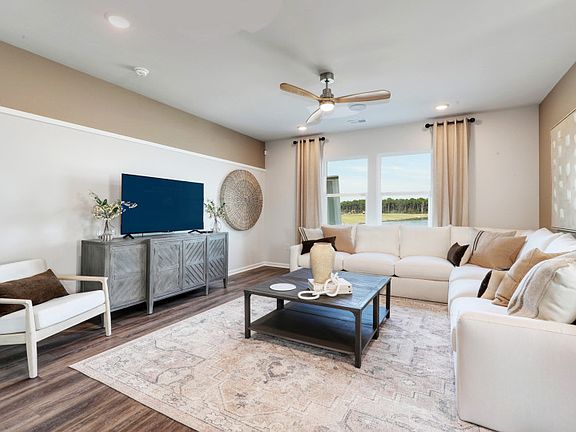 Spacious Gathering Room with large window adding plenty of natural light to the entertaining space.