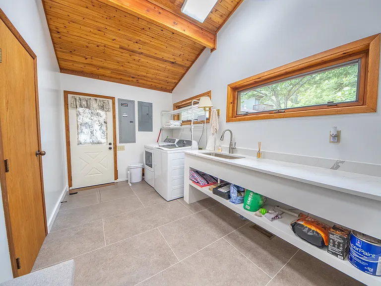 Laundry with internet linked washer and dryer and half bath.