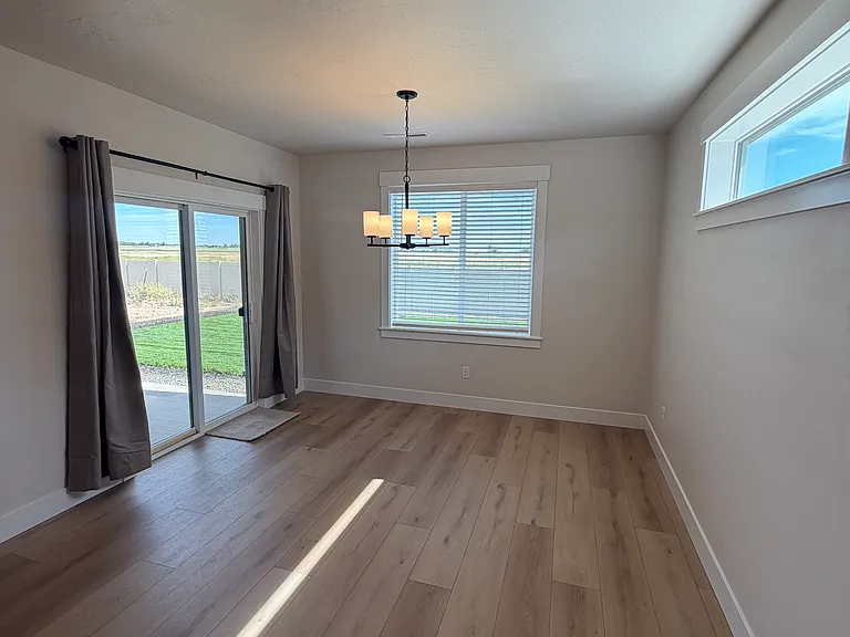 The spacious dining area is ideally situated within the open-concept floor plan, providing an elegant setting for family dinners, holiday gatherings, and entertaining guests.