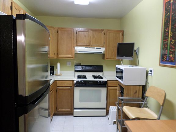Kitchen with stainless steel refrigerator
