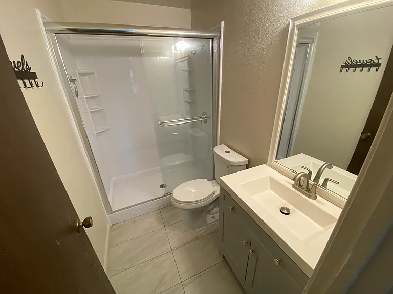 renovated master bath with new shower , vanity, faucet and flooring