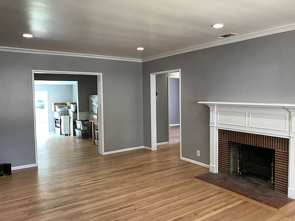 Enter the living room, with a coat closet in the entry way. To the right are two bedrooms joined by a bathroom. The larger opening leads to the dining room, family room and kitchen.