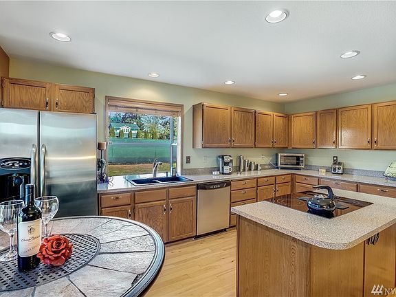 Chef's kitchen with quality Stainless Steel Appliances, an eating nook and ample counters, cabinets and pantry. Rich maple hardwood floors on entire main floor.