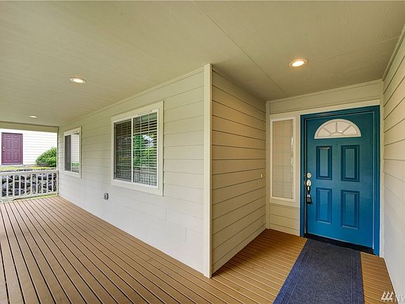 A front deck has room for outdoor sitting furniture, a perfect place for a porch swing.
