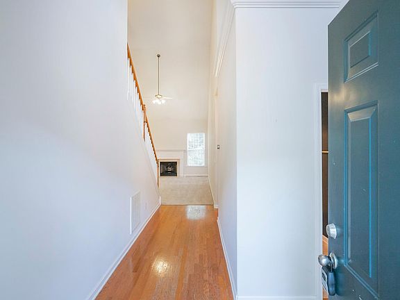 Immediately ahead is a bathroom, with two bedrooms to the right. The primary bedroom is to the right just before the carpet begins.