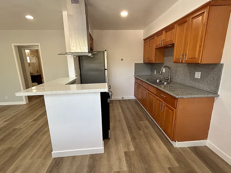 Kitchen with wooden cabinets and granite counter tops.