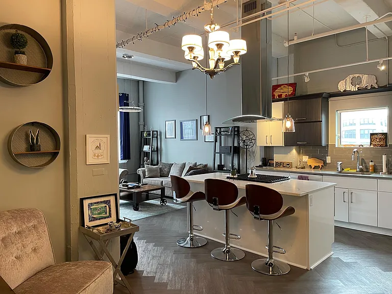 Kitchen island shown with chairs