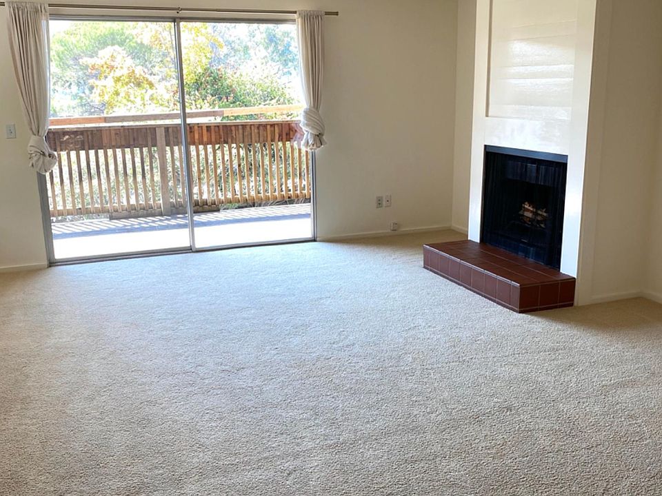 Large living/dining area with fireplace and easy access to a deck.