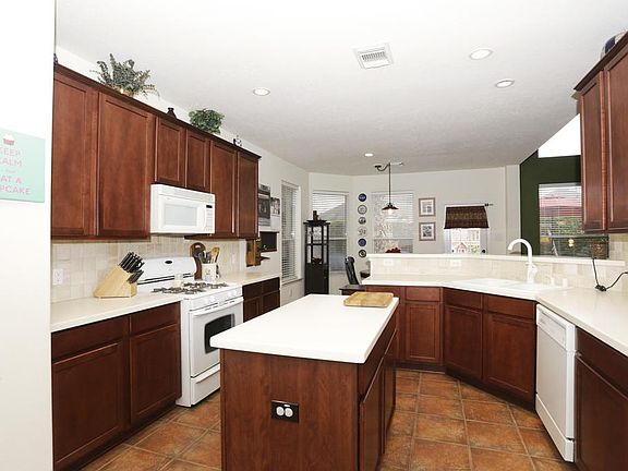 A cook's dream kitchen featuring plenty of preparation space, gas range, and 42" cabinets.