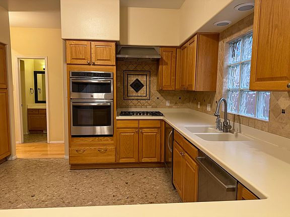 Kitchen with all new updated stainless appliances: stove/microwave combo, range, wine fridge, Bosch dishwasher and extra large fridge with craft ice