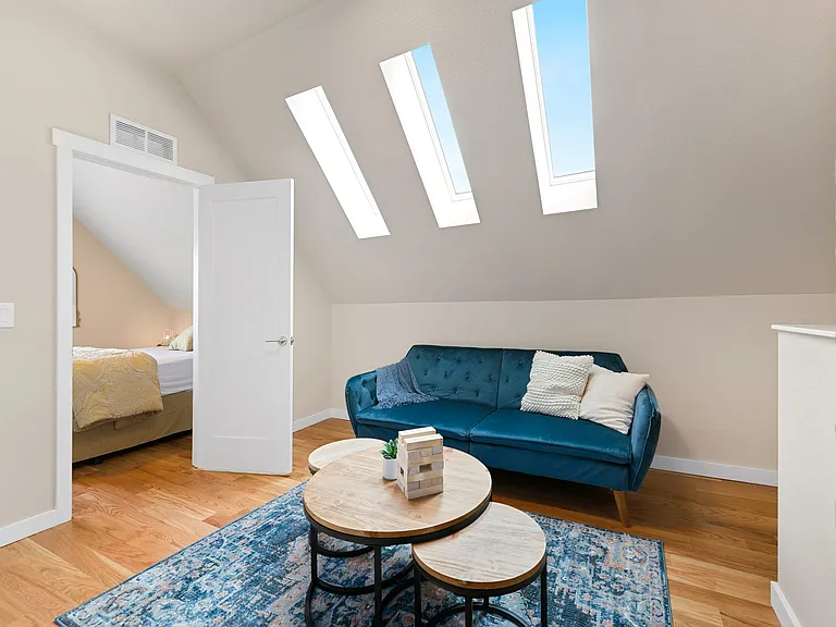 sitting area with 3 skylights at the top of the stairs... blue couch fold down for sleeping