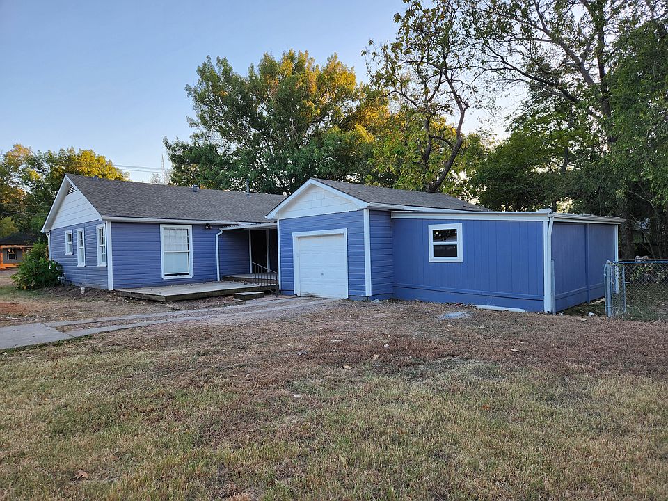 Large, partially covered deck at side entrance.