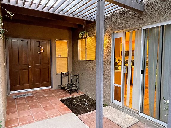 Front entrance with slider into kitchen and removable dog door 18" x 10".