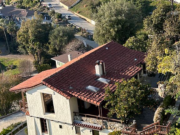 View of the back of the house from a neighbor's balcony. The owner lives on the top floor. The 2 studio units are entered from this side of the house, so you'll share your stairway ONLY with the owner.