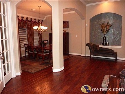 Grand front entry with gleaming hardwood floors