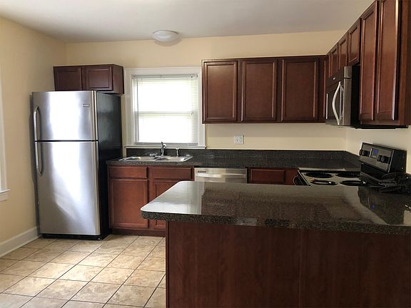 Stainless steel appliances with a breakfast bar.