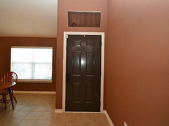 Entry offering tile floors and raised ceilings.