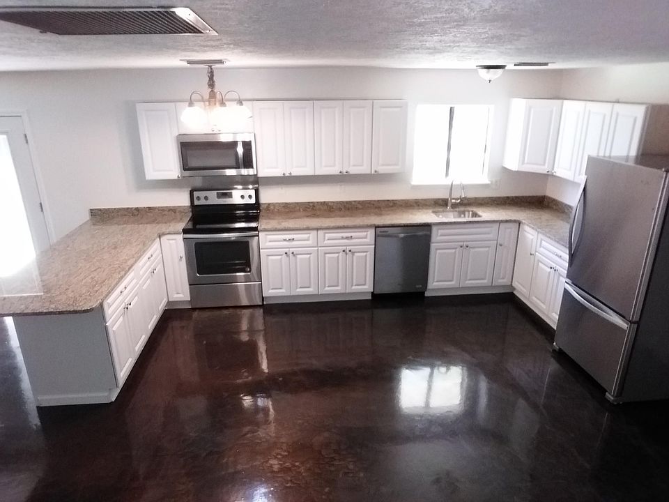 Kitchen view. Single basin sink w/water heater and drip pan 