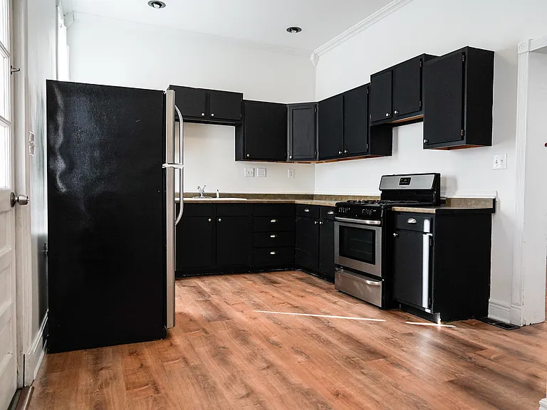 The kitchen features loads of cabinet storage.