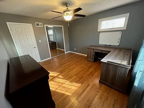 Master Bedroom. Has a long dresser and a desk that can be used or removed. Mirror closets plus a NEW ceiling fan/light that matches 3 other rooms. Hardwood Oak is beautiful.