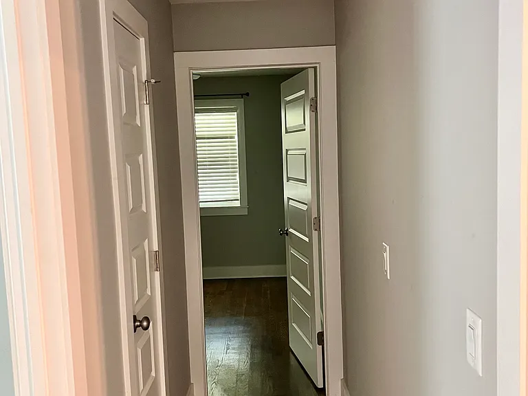 Hallway to second bed room with two storage closets