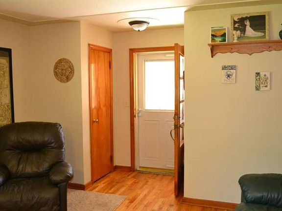 The front entrance features a closet for your winter coats.  You are welcomed into the front living room area with the wood flooring conecting the areas together. 