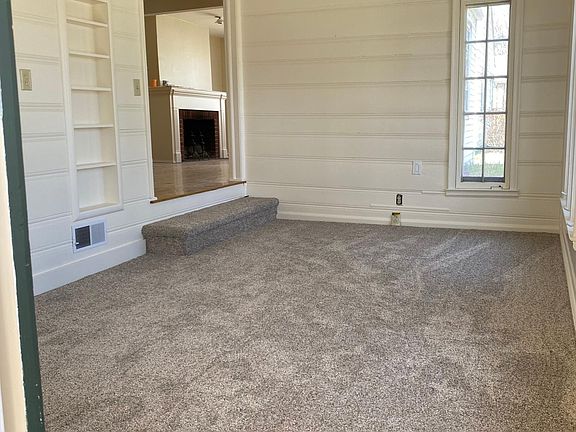Entry way from covered car port. Light, bright sunroom with new carpet and tiled entry.
