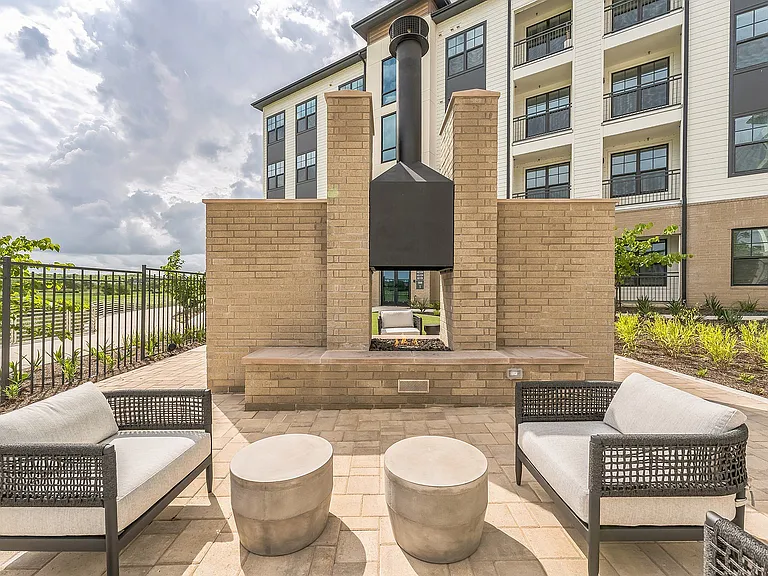 Cozy up by the fireplace in the courtyard