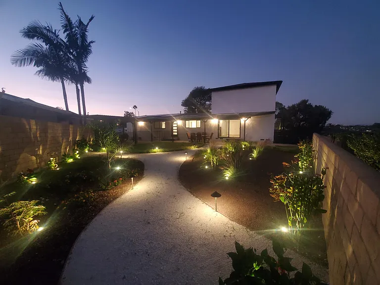 Designer landscape with fenced yard.