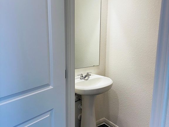 Bathroom on the left side as you walk towards the living room from the entry.