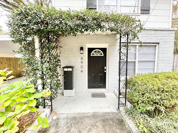 Jasmine draped front entryway w/ private mailbox