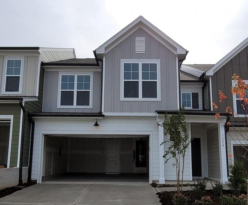 Front, 2 car garage with additional parking space on driveway.