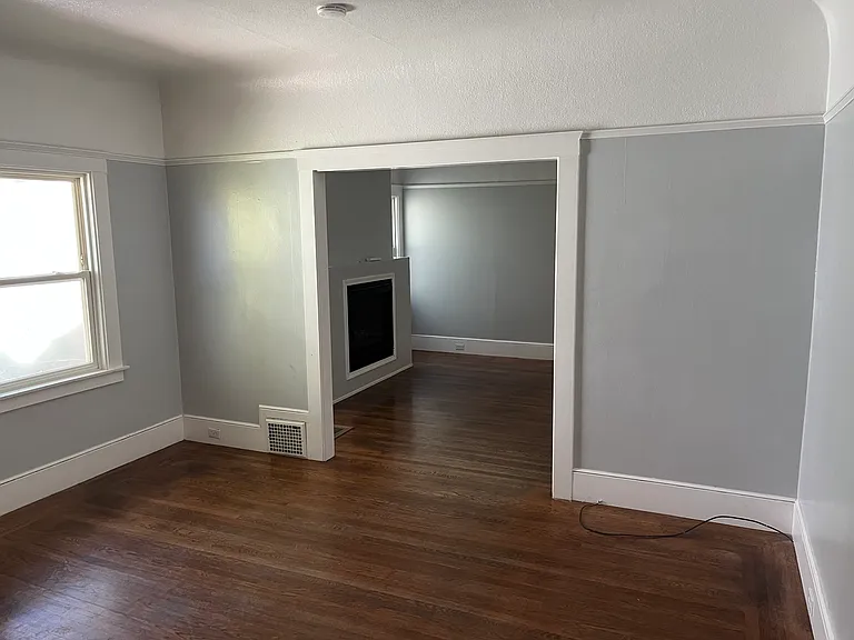 Original beautiful solid wood flooring, separate living and dining areas with Electric fireplace