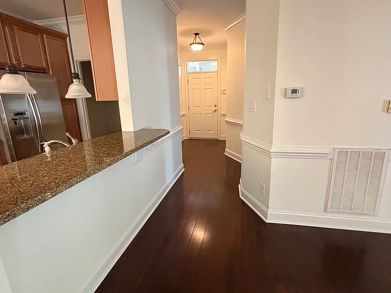 living room looking at hallway to front door, if go right before the door leads you to full secondary bathroom and large secondary bedroom