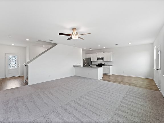 Open-concept layout with a spacious living room and upgraded kitchen.