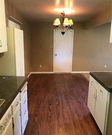Kitchen has updated laminate flooring
