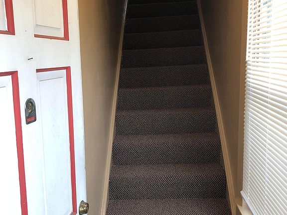 Front door and stairs leading up to unit. Brand new carpet on stairs.