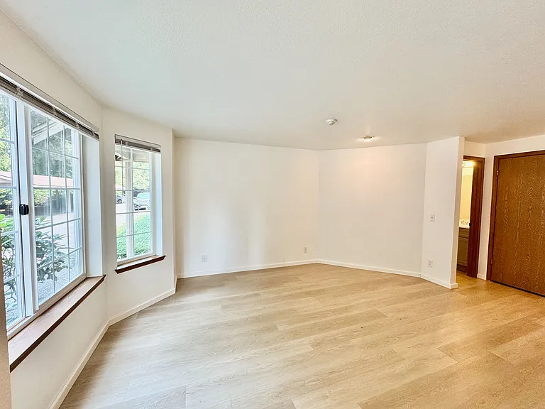 Enter into the living room with brand new flooring, half bath and coat closet.