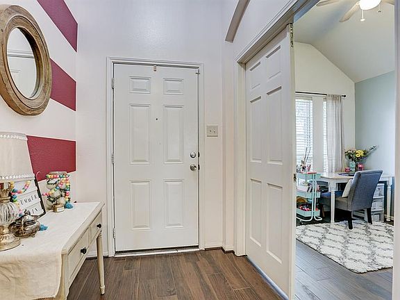 Welcoming entry with decorative paint leads you into this lovely home.