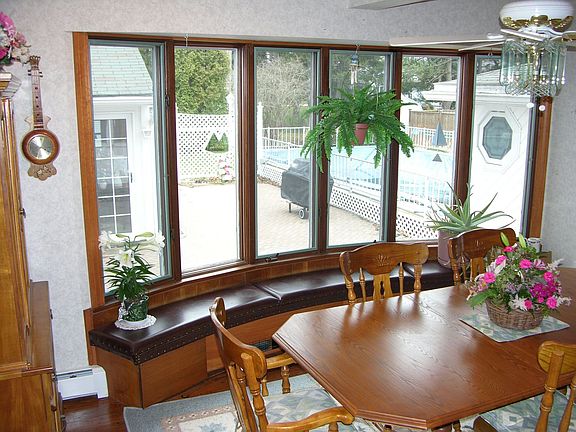 Large bay windows look to the sun room and sauna/ spa