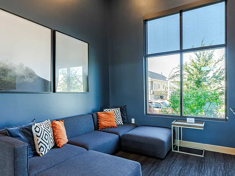 Kick back with friends or enjoy solo downtime in the resident gaming lounge featuring comfortable seating, a video game console setup, and a relaxed modern atmosphere.