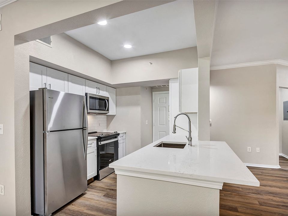 Renovated deluxe home featuring white cabinets and stainless steel appliances