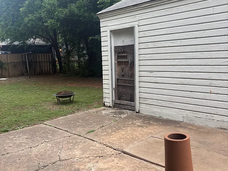Large backyard with storage building.