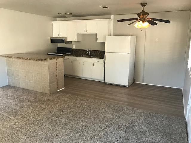 Open concept kitchen and living room. Granite countertops & disposal in sink.