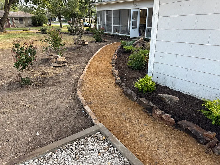 Gravel pathway, part of the thoughtful landscaping around the property.