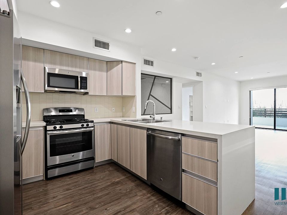 Kitchen with Energy-Efficient Stainless Appliances and Countertop Bar