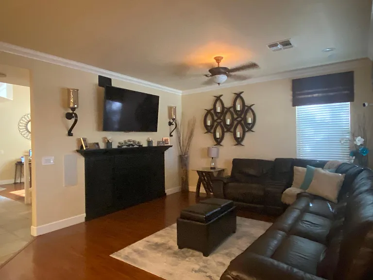 Living room with built in entertainment center with electrical outlets located behind the wall.