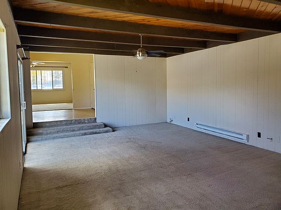 Back Living Space with view to front living space with kitchen area in between.